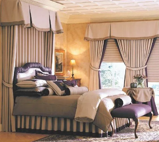 Custom bedding and an upholstered bench in an elegant bedroom