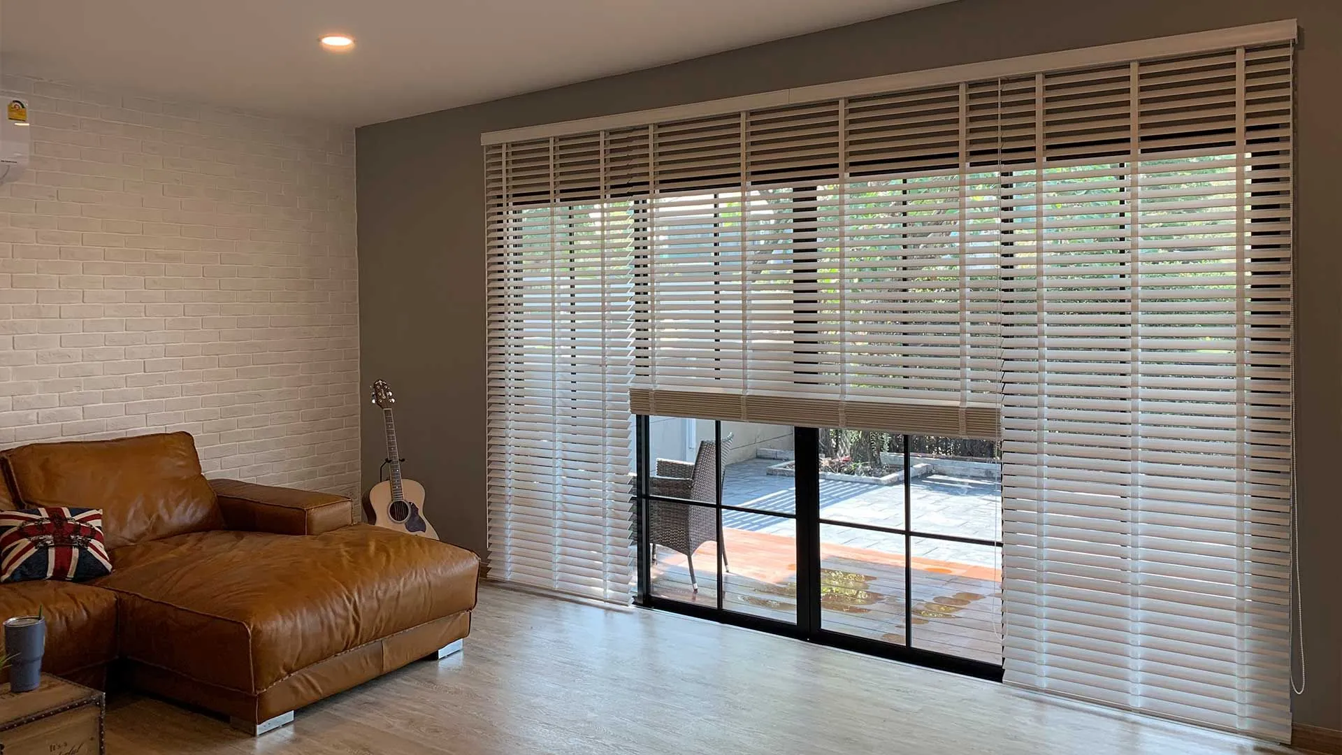 Faux wood blinds covering large patio doors in a living room